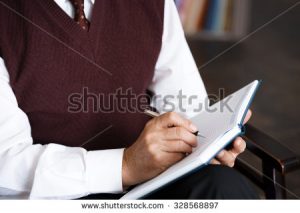 stock-photo-close-up-photo-of-male-psychologist-psychologist-making-notes-in-psychologist-office-328568897