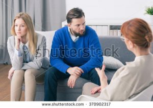 stock-photo-husband-and-wife-during-session-with-psychologist-370902317