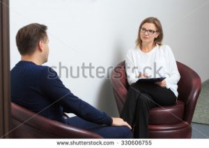 stock-photo-psychologist-consulting-pensive-man-during-psychological-therapy-session-330606755