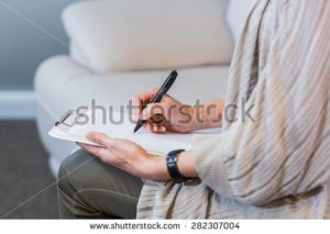 stock-photo-psychologist-sitting-on-the-couch-and-taking-notes-in-the-office-282307004