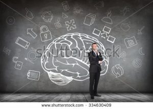 stock-photo-woman-stands-beside-big-drawn-brain-on-the-gray-wall-334630409